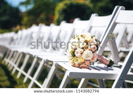 Wedding bouquet on white chairs. Close-up Royalty-Free Stock Photo #1143082796