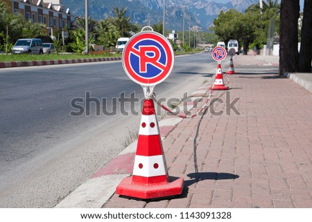 road sign "no parking" stands near the roadway, in the city