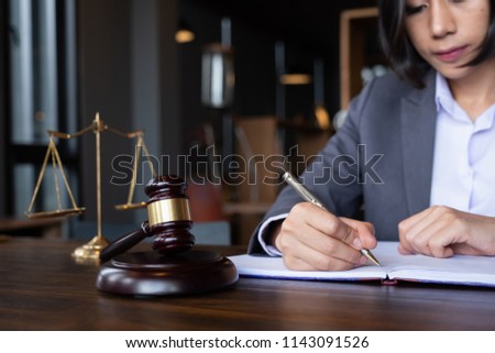 Judge gavel with Justice lawyers, Business woam in suit or lawyer working on a documents. Legal law, advice and justice concept.