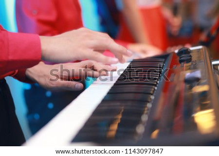 Pianist musician performing live playing keyboard in a band