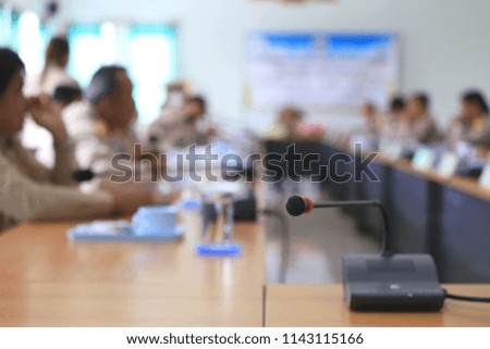 Close-up microphones in conference room people sit in the conference room in the background selective focus and shallow depth of field