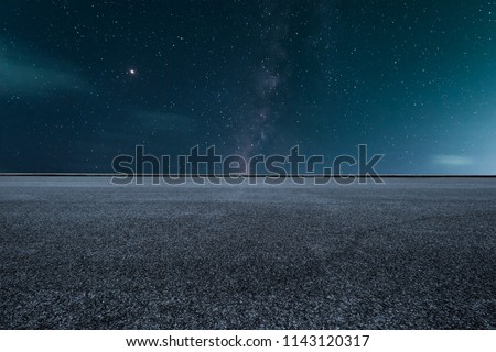 The empty highway under the starry night sky