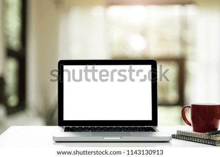 Workspace wood desk with Laptop with blank screen,White Office Interior blurred background at light bokeh.