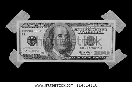  $100 Dollar Bill and masking tape isolated on black background