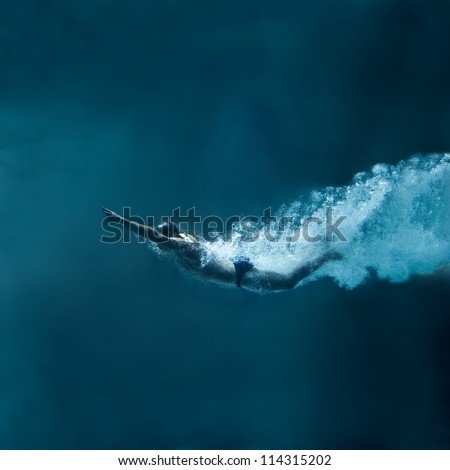 professional swimmer underwater after the jump Royalty-Free Stock Photo #114315202