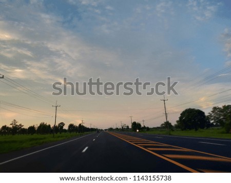 Evening sun Traffic routes are white black and yellow Blue sky and beautiful white clouds background Copy Space