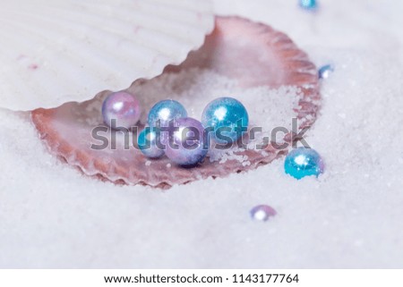 Beautiful pearls and shells are on the sand