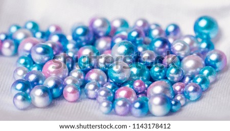 Coloured pearls are on the silk cloth