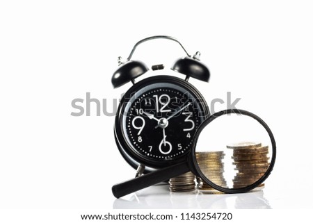 concept alarm clock and coins on white