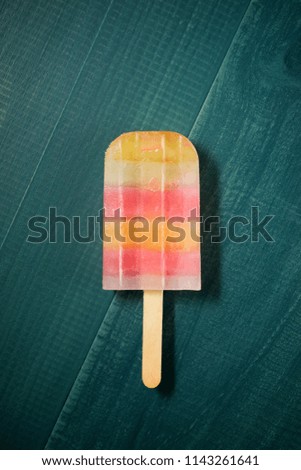 Popsicle on a wood table.