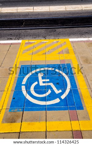 Yellow sign for parking space reserved for disabled people