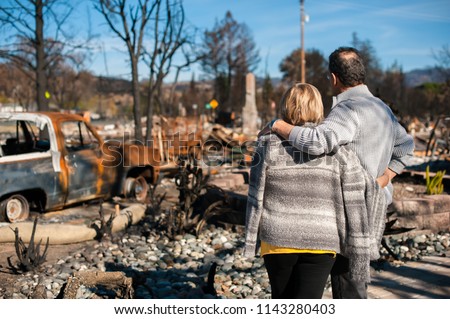 Man and his wife owners, checking burned and ruined of their house and yard after fire, consequences of fire disaster accident. Ruins after fire disaster. Royalty-Free Stock Photo #1143280403