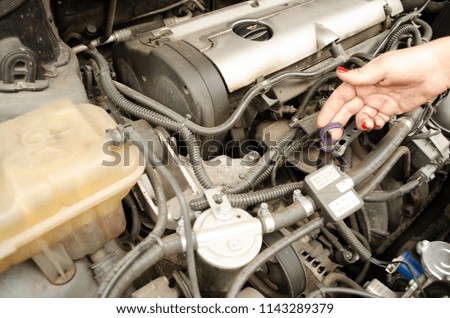 The motor oil level checking. The car motor with engine oil cap. Close up view. Auto mechanics. 