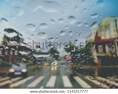 rain drops on car glass on the road. bokeh 
