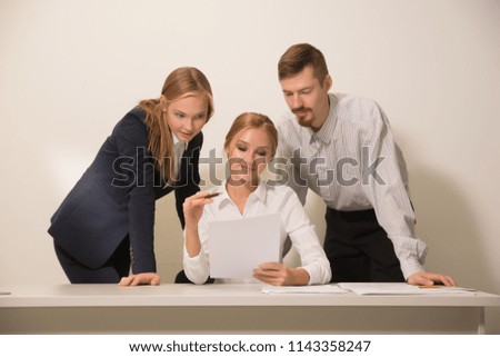 3 people work in the office, talking to, and address the issues of the company, smile and sign documents