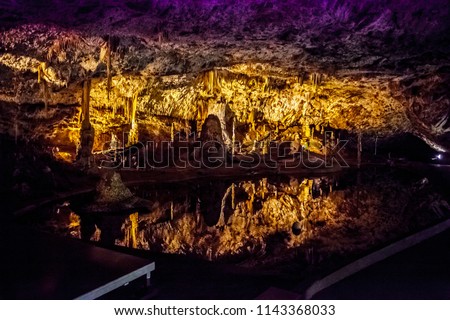 Beautifully illuminated arch of the Punkva cave above the underground lake in Moravian Karst, Czech Republic. Royalty-Free Stock Photo #1143368033