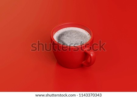 a cup of strong coffee on a red background