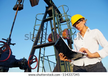 Businesswoman with a notebook in an oilfield