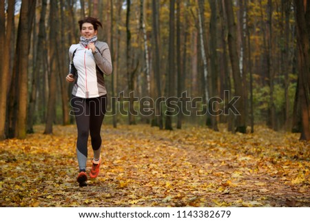 Full-length photo of athlete woman on morning run