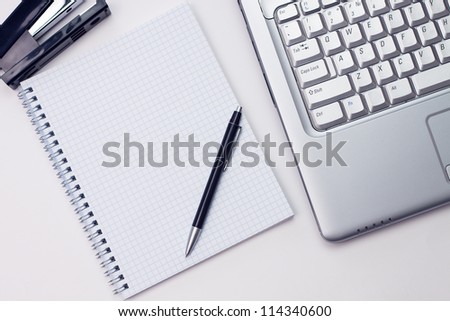 blank notepad and laptop in the office Royalty-Free Stock Photo #114340600