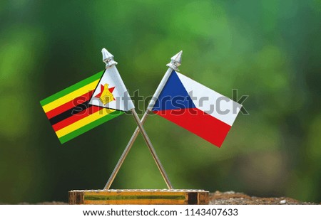 Czech Republic and Zimbabwe small flag with blur green background