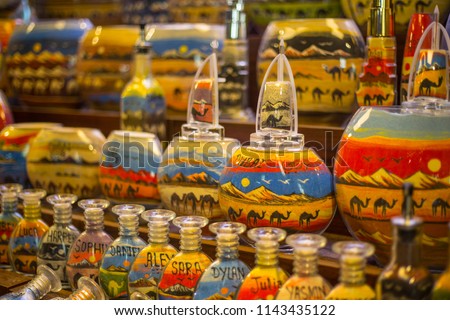 Sand bottle souvenirs at the Madinat Jumeirah Souk, Dubai, UAE. Decorative glass bottles with colored sand inside making shapes of desert and camels
