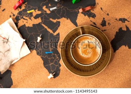 A cup of fragrant coffee on the map, a vintage photo. Travel and holidays. Copy space.