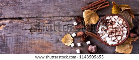 Hot cocoa with marshmallows with spices on the old wooden boards. Coffee, cocoa, cinnamon, nuts, star anise, cozy sweater
Autumn Still Life