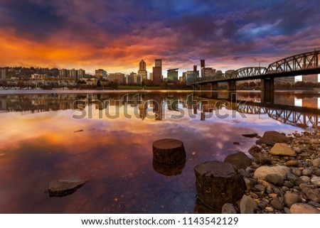 A beautiful sunset over downtown Portland Oregon waterfront along Willamette River from Eastbank Esplanade