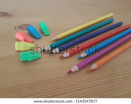 Colored pencils and erasers laying on a wooden desk, Back to school, Back to school, Drawing utensils