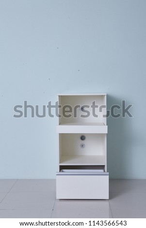 White storage stand with ceramic and dishware in kitchen. modern kitchen furniture. japanese modern Kitchen storage furniture. Dining Room.