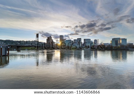 Sunset over the City of Portland Oregon downtown waterfront by Hawthorne Bridge along Willamette River