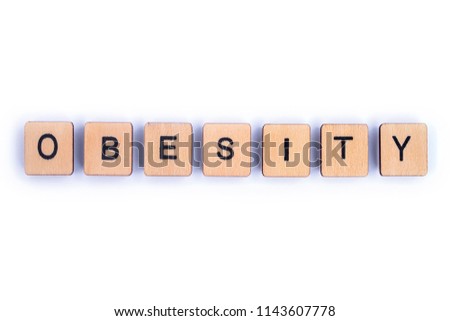 The word OBESITY, spelt with wooden letter tiles.