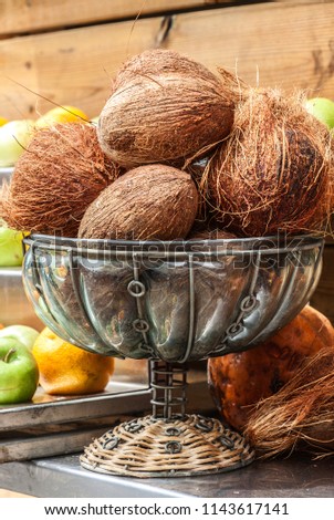 Close up of  whole fresh brown coconuts on retail market. Israel. 