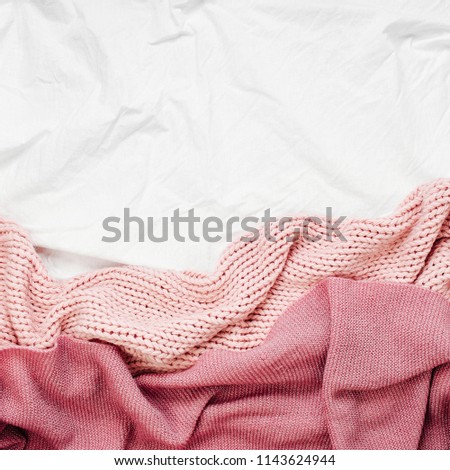 Bedding with pink warm plaid. Copy space. Flat lay, top view