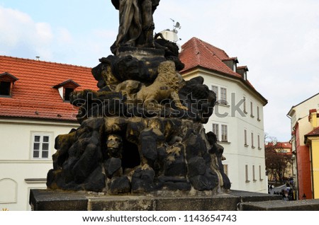 Ancient Statue on Charles Bridge (Karluv most) - famous historic bridge in Prague, Czech Republic
