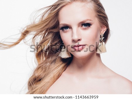 Curly hair blonde woman with long beautiful hairstyle and beauty lashes isolated on white