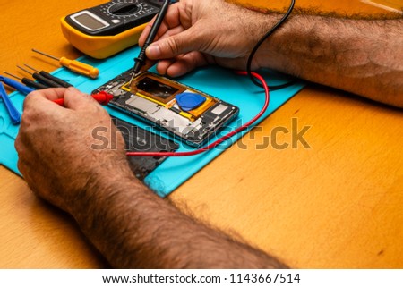Close up photos showing cess of mobile phone repair smart phone.