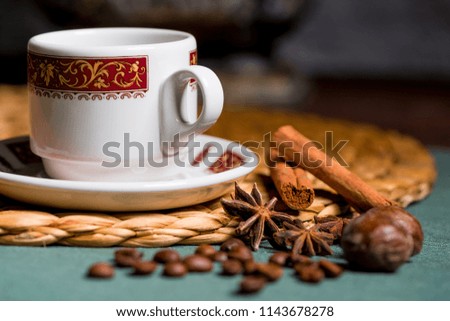 horizontal picture of a beautiful cup of coffee, anise and cinnamon still life on a table