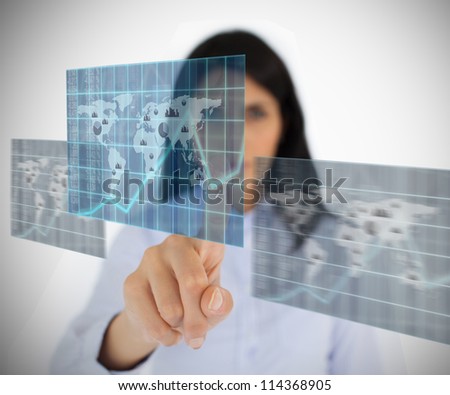 Woman selecting world map image from hologram interface on white background