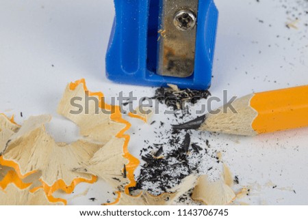Pencil and sharpener on a white table. Accessories for drawing and sketching. White background.