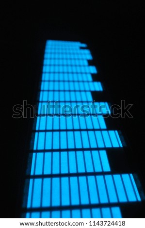 Glowing stylish light structure, neon and graphic blue equalizer on a black background, splash screen