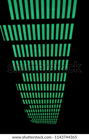 Yellow and green glowing light structure and graphic equalizer on a black background, splash screen