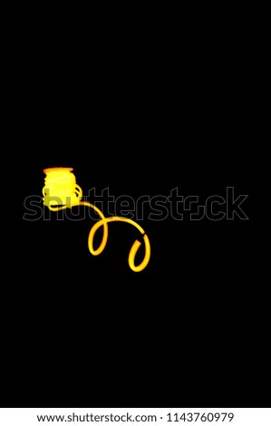 Frosted five millimeters, luminous wire electroblinded cable with neon, yellow light and color on a black background