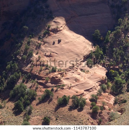 Abstract photo of two boulders precariously balanced on steep sandstone slope; Antelope House overlook; Canyon de Chelly National Mounument in Arizona