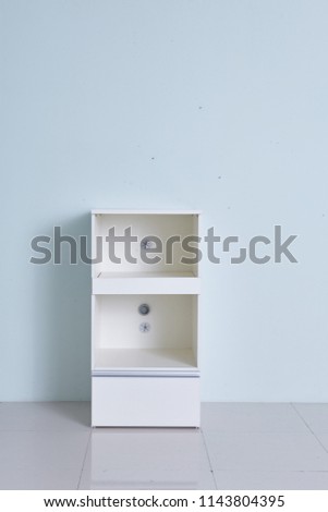White storage stand with ceramic and dishware in kitchen. modern kitchen furniture. japanese modern Kitchen storage furniture. Dining Room.