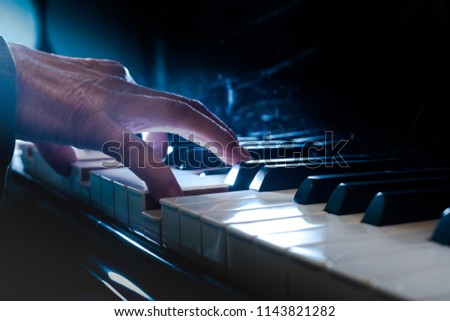 Pianist's hands playing on a keyboard