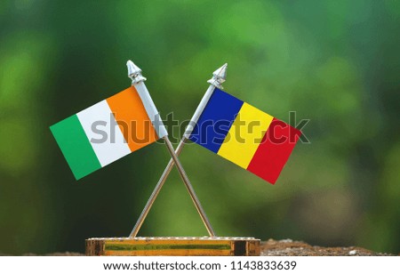 Romania and Cote d'Ivoire small flag with blur green background