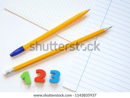  sheets of school notebooks, pen and pencil, bright numbers are on a white background. Go to school. The first of September.