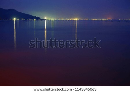 Long exposure shot of Lake view at Southern Thailand on sunset time background,Long exposure shot lake view with colored sky over lake on sunset time background.                             
